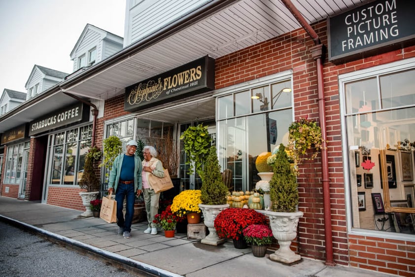 Senior couple walking out of store